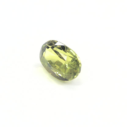 Natural green sapphire 1.64ct unheated oval gemstone on white background