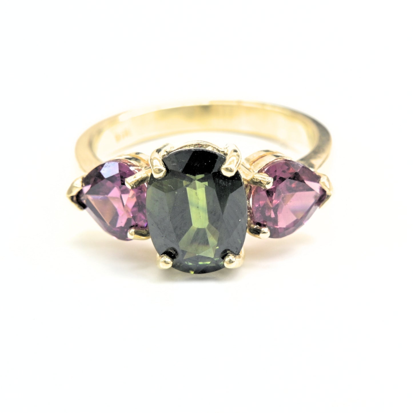 Trilogy gemstone ring in yellow gold with green sapphire center and rhodolite gems