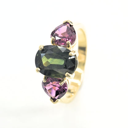 Handcrafted gold ring set with green sapphire and pear-cut rhodolite gemstones