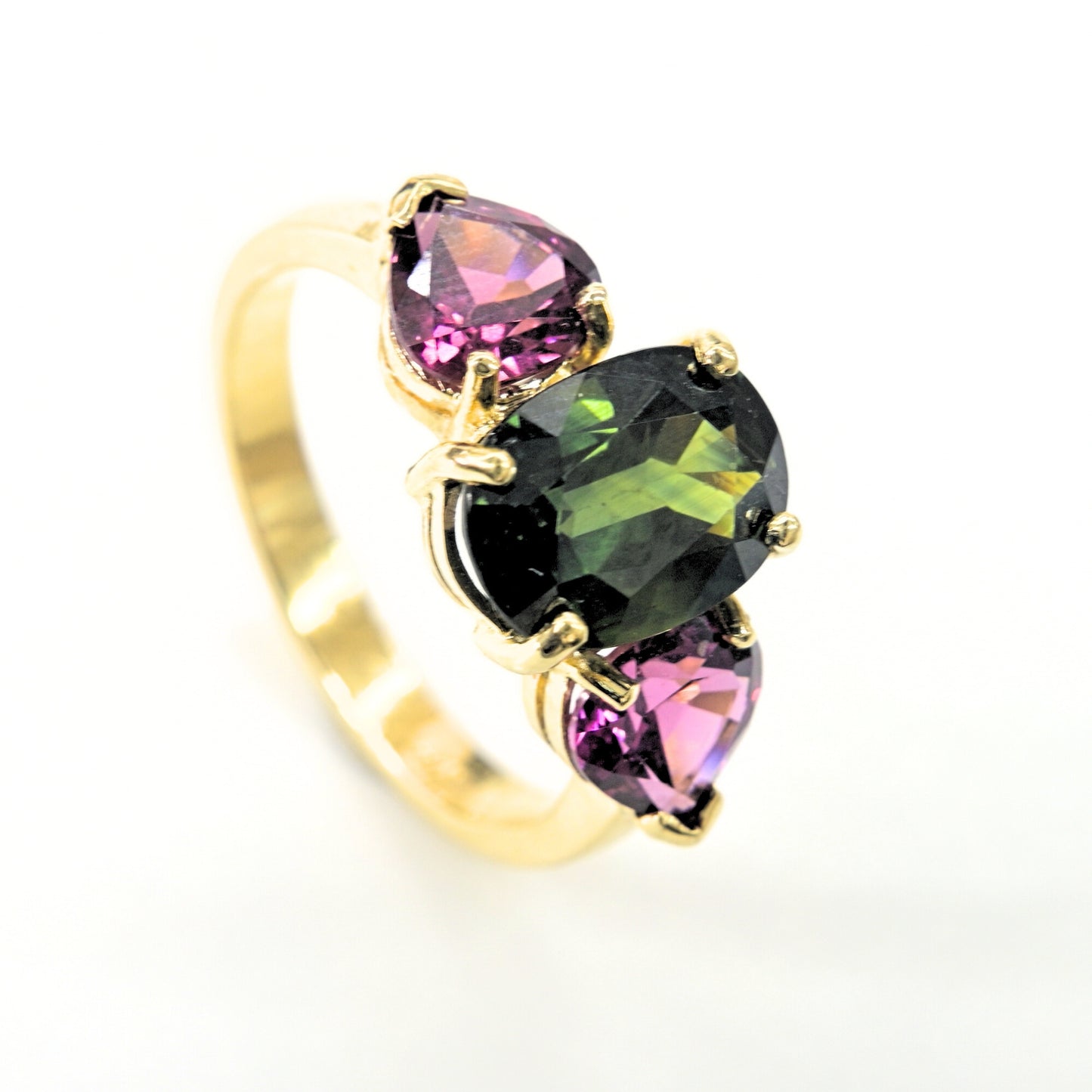 Luxury gemstone ring in 18K gold with green sapphire and rhodolite accents