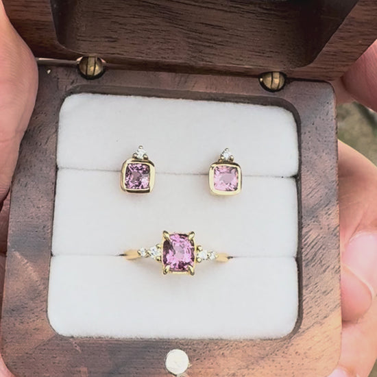Fine jewelry pink spinel and diamond stud earrings handcrafted in solid 14K yellow gold in Chiang Mai, Thailand.