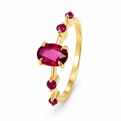 A gold ring featuring a oval-cut ruby and four smaller round-cut ruby set in 14K gold