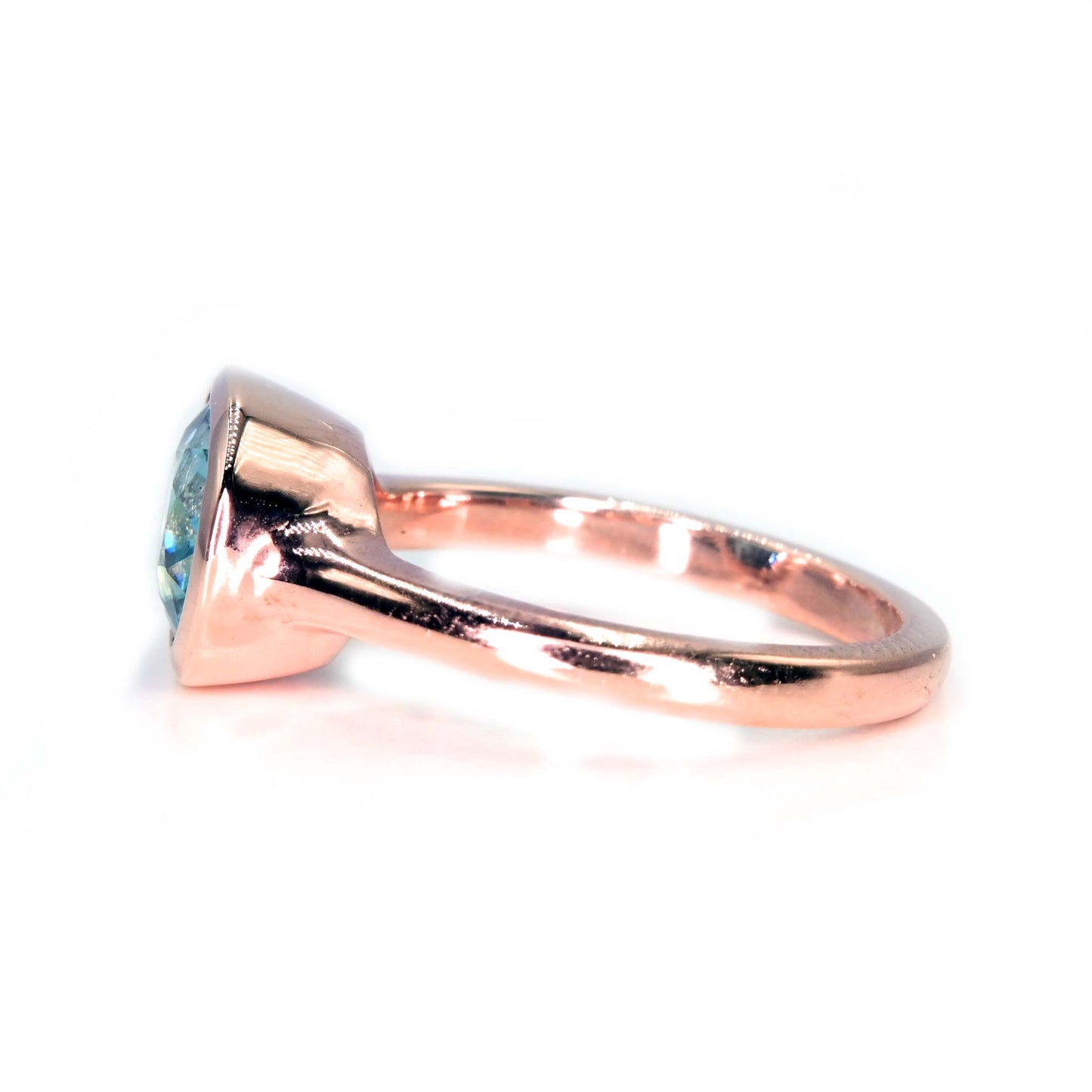 Side view of our handmade ring with Thailand blue zircon and rose gold