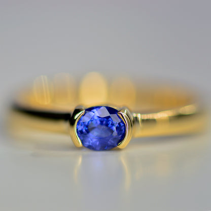 Customer selected blue sapphire made into a ring in 18K yellow gold.
