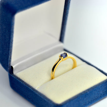 Engagement ring with blue sapphire in a box