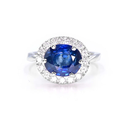 Natural blue sapphire ring with diamond halo setting in 18K white gold, handcrafted in Chiang Mai