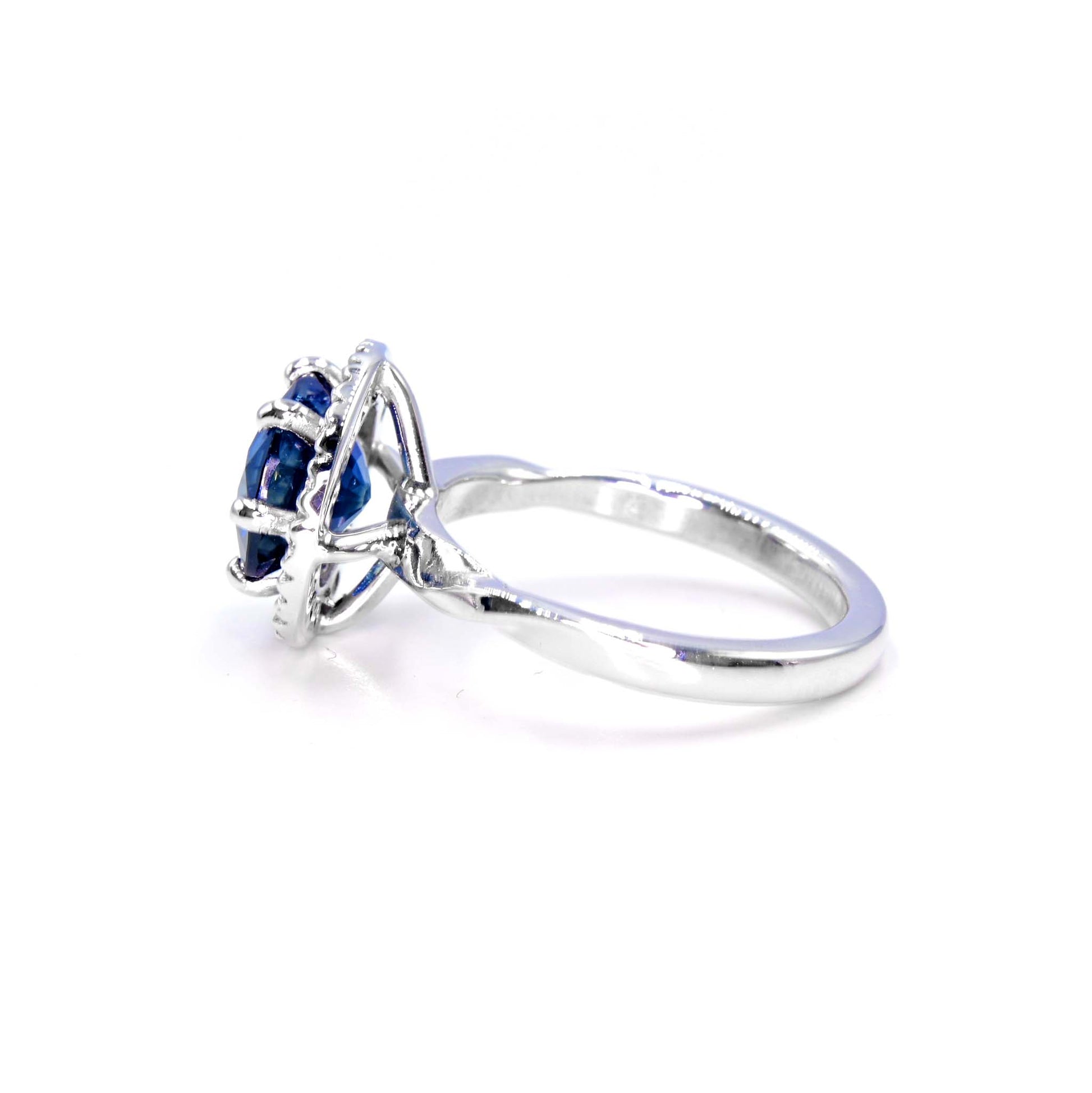 Elegant sapphire and diamond halo ring, handmade fine jewelry in 18K white gold