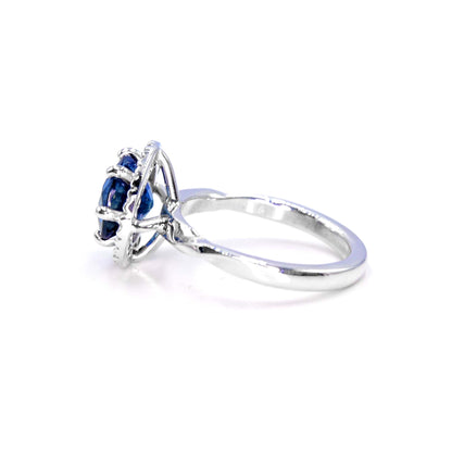 Elegant sapphire and diamond halo ring, handmade fine jewelry in 18K white gold