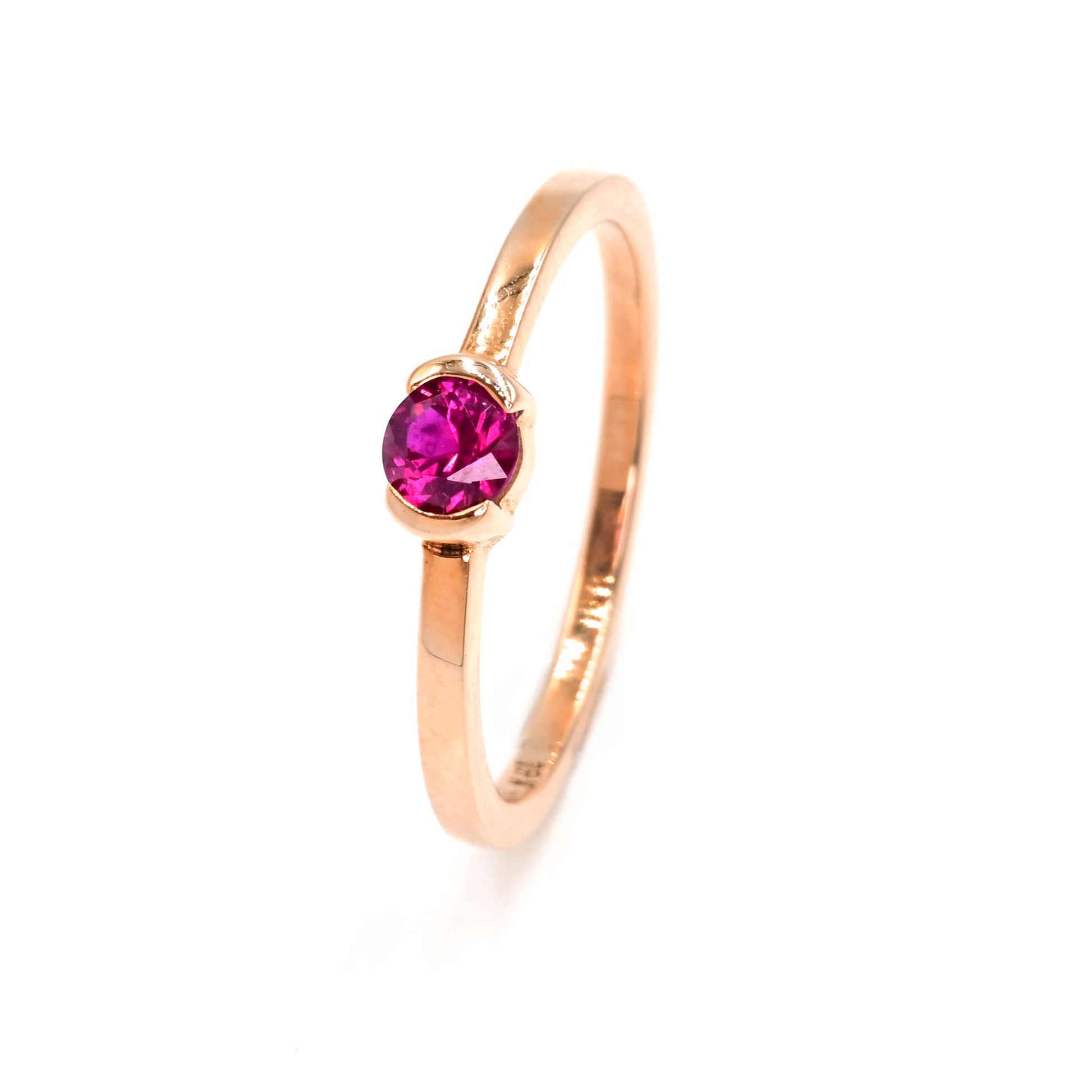 Half-bezel ruby ring in rose gold is a head turner. Handmade jewelry from Shiraz Jewelry in Chiang Mai, Thailand