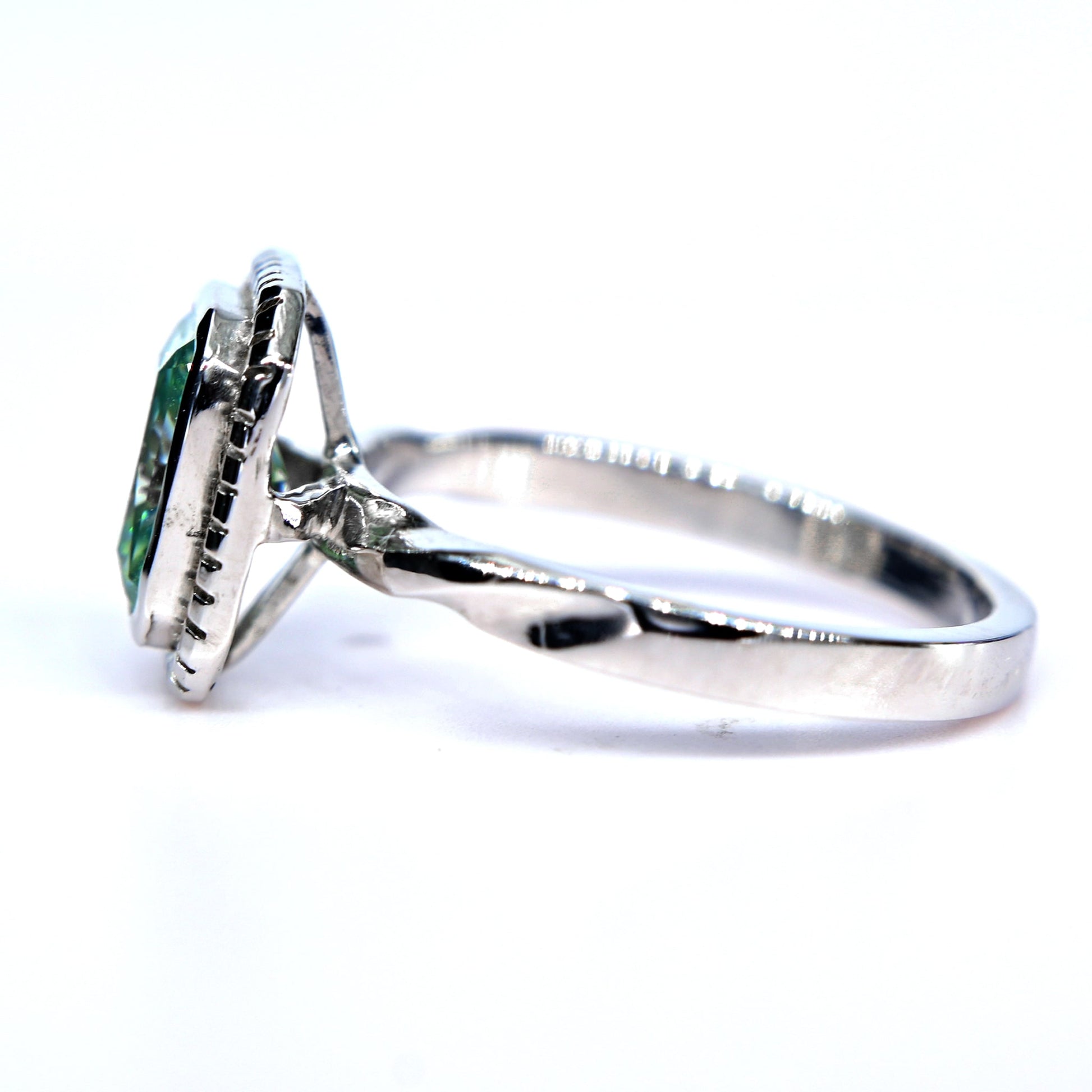 Shiraz Jewelry blue green moissanite ring with twisted white gold band and bezel setting